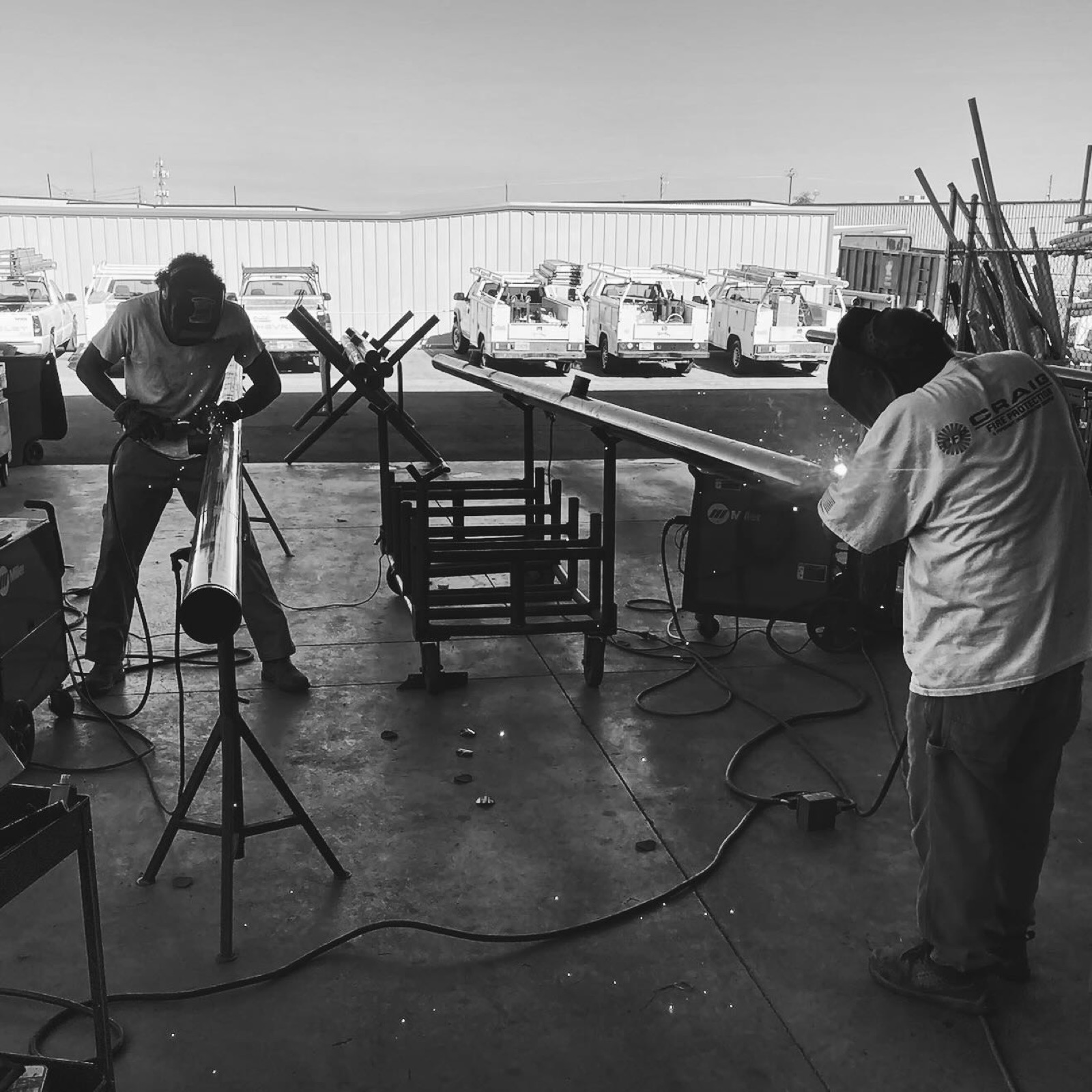 Crew welding sprinkler pipe in the fabrication shop